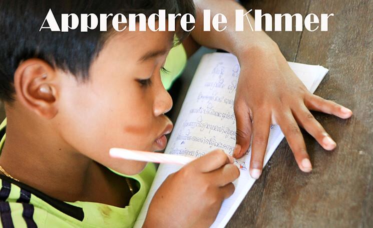 un enfant s'applique à l'écriture