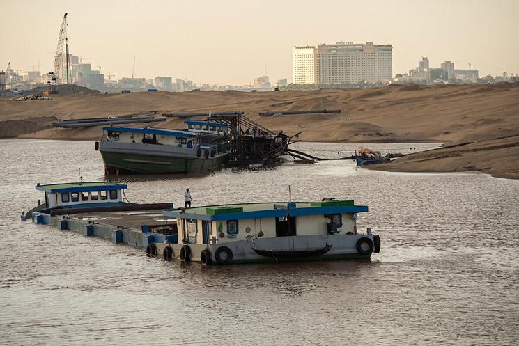 A heavily laden barge brings sand to another reclamation area on the outskirts of Phnom Penh, Cambodia