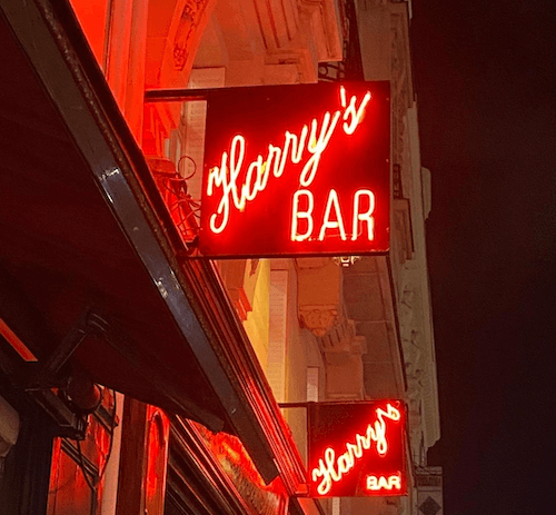 l'enseigne du Harry's bar à Paris brille dans la nuit 