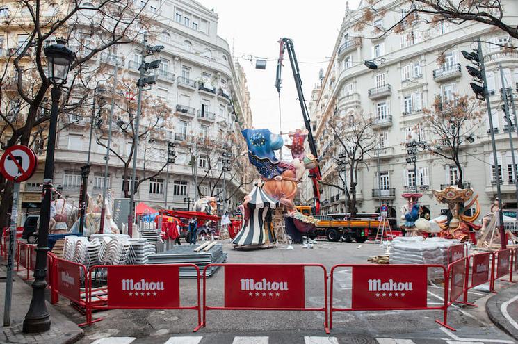 une grue sur une place avec une figure en construction