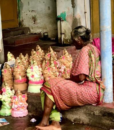 Une vieille dame vendant ses statuettes de Ganesh